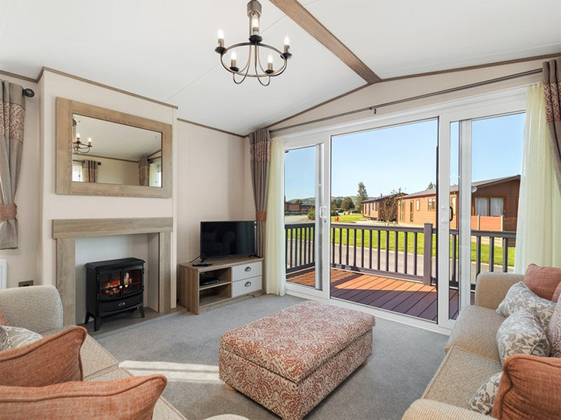 ABI Ambleside - lounge with large patio doors and log burning style fire