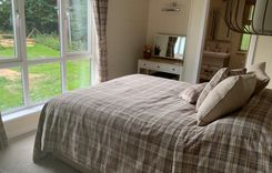 a comfy warm bedroom with ensuite facilities