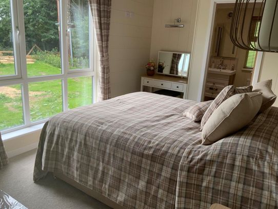 a comfy warm bedroom with ensuite facilities