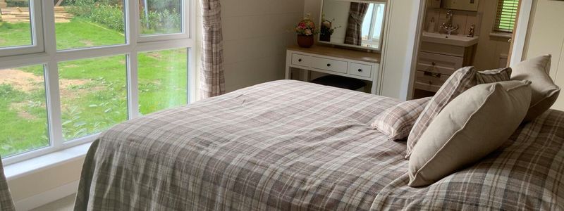 a comfy warm bedroom with ensuite facilities